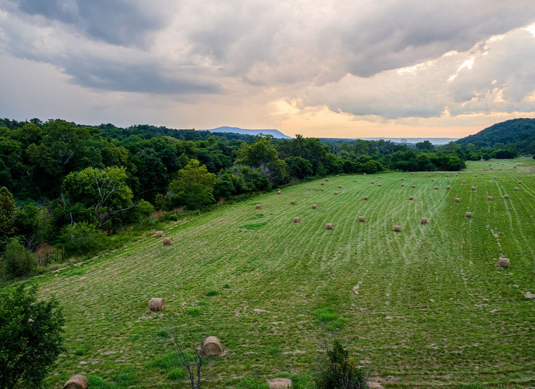 Contact - Open Field With Hey Bales Overlooking the Shenandoah Valley With Warm Colored Clouds